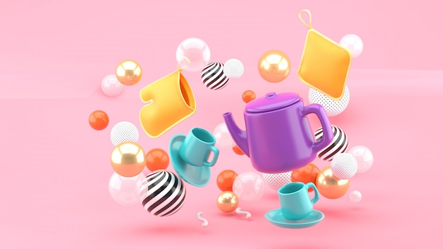 A tea set amid colorful balls on a pink space