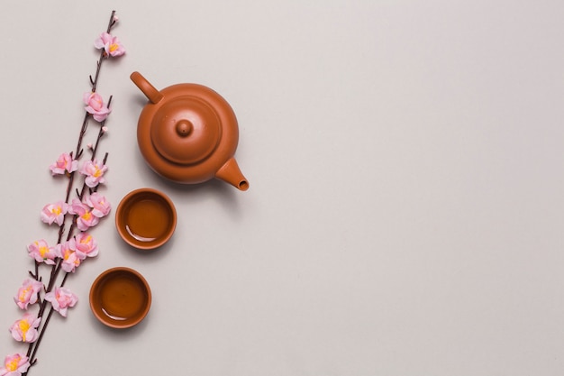 Tea set and cherry blossom branch