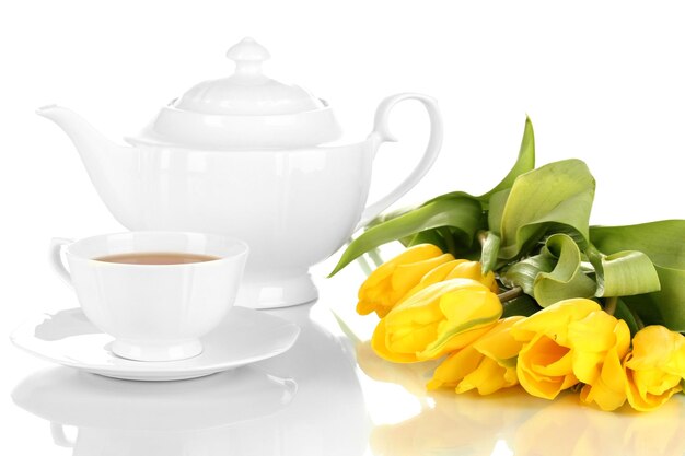 Tea set and tulips isolated on white