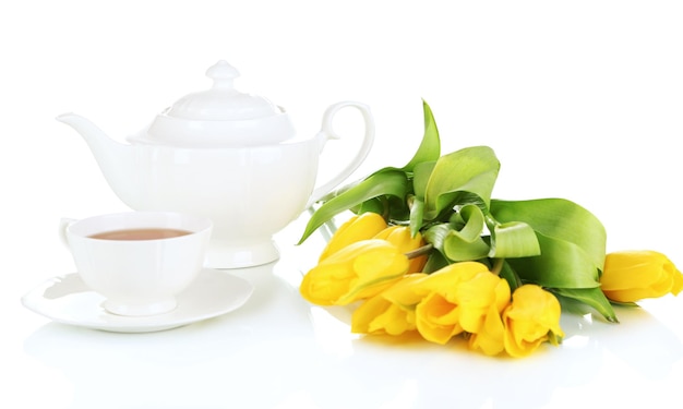 Tea set and tulips isolated on white