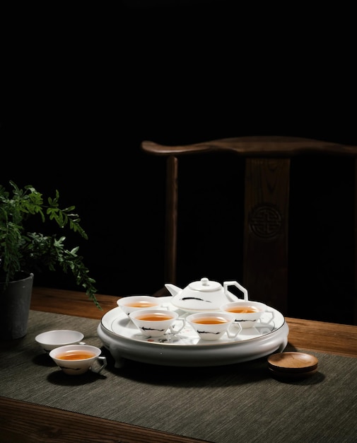 A tea set with cups and saucers on a table