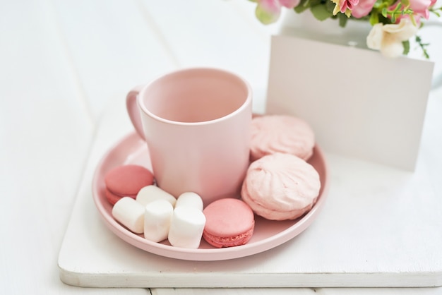 Tea set with flowers and sweet. Copy space.