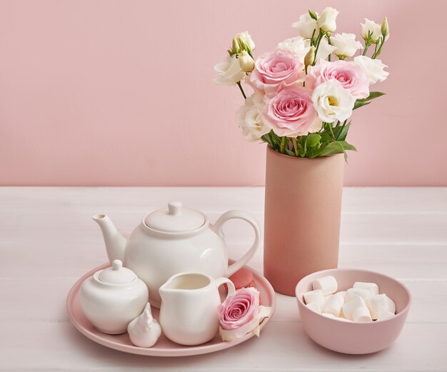 Tea set with flowers and sweet