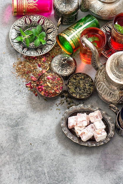 Tea table place setting with colorful glasses. Oriental hospitality concept