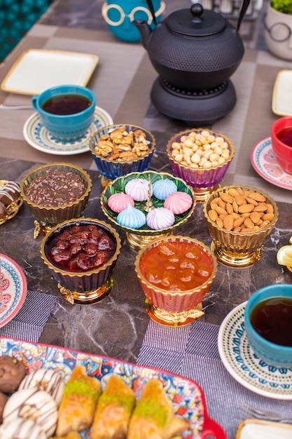 tea table with dried fruits and jam and other sweets