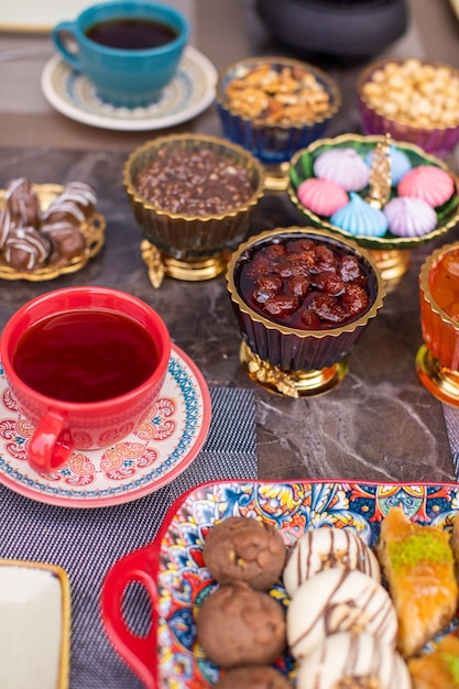 tea table with dried fruits and jam and other sweets