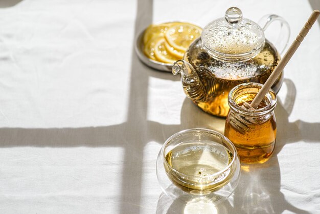 tea in a teapot and a glass nearby