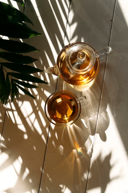 tea in a teapot in the sun on background close up