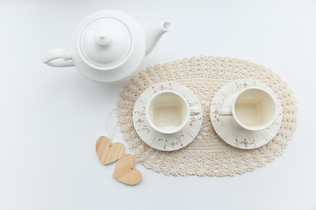 Tea for two two white cups of tea with two hearts and kettle