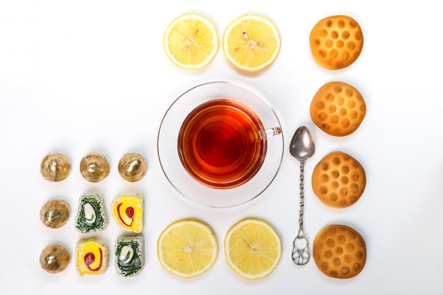 Tea with biscuits and lemon.