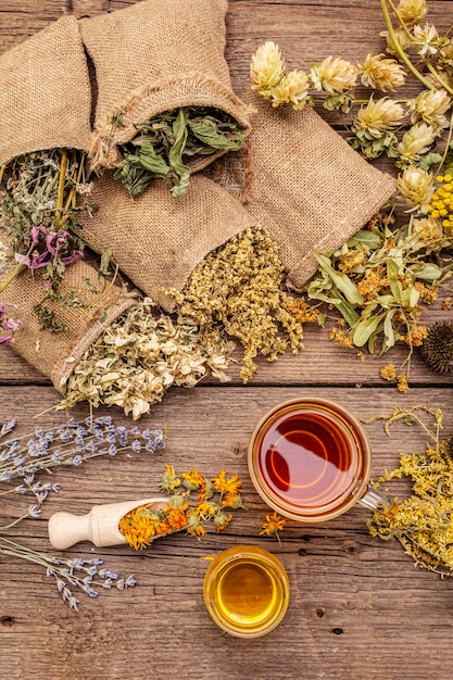 Tea with honey. Herbal harvest collection and bouquets of wild herbs. Alternative medicine. Natural pharmacy, self-care concept