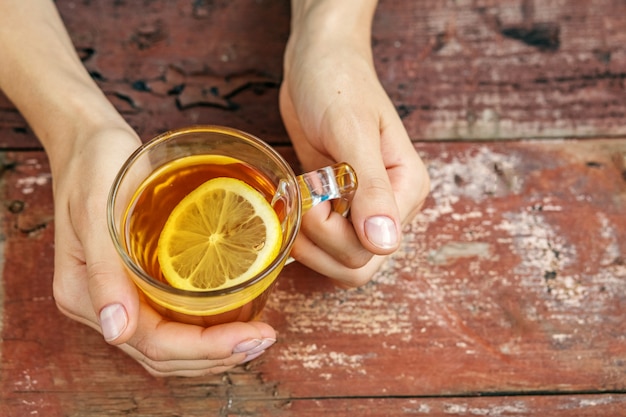 Tea with lemon. Hands. 