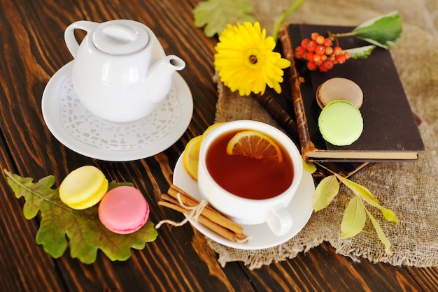 Tea with lemon on a wooden background