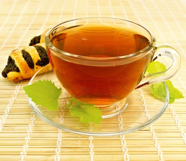 Tea with mint and cookies on a bamboo napkin