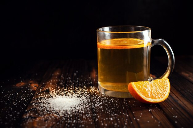 Tea with orange sprinkled sugar sliced orange