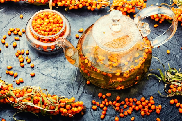 Tea with sea buckthorn. Delicious medicinal tea from autumn berries in glass teapot