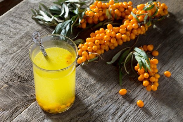 Tea with seabuckthorn berries branch