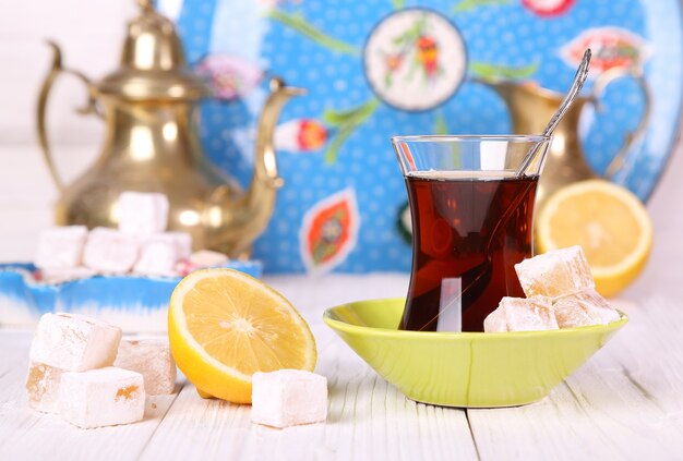 Tea with Turkish Delight and lemon on a white table