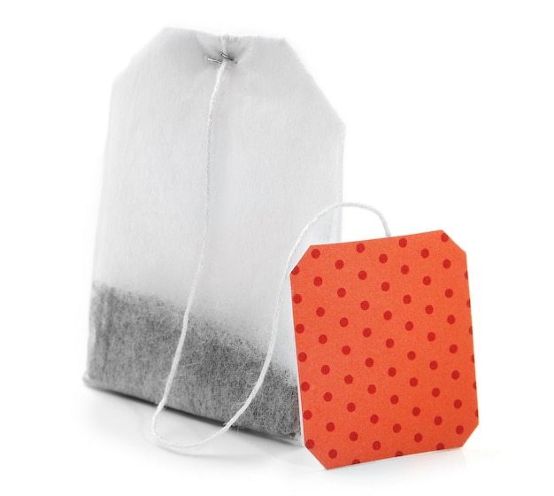 Teabag with red dotted label isolated on white background