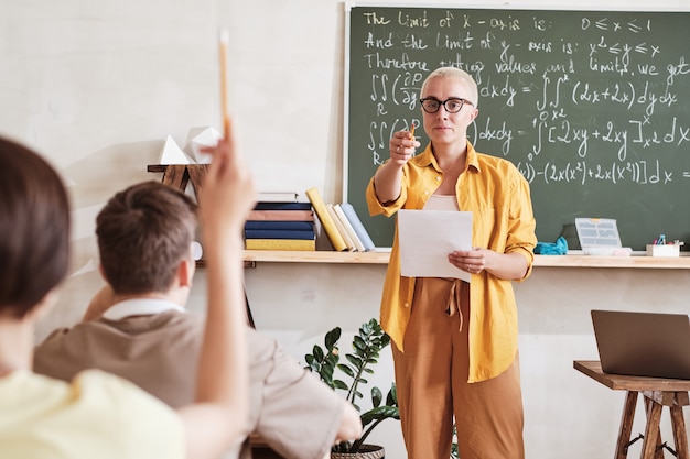 Teacher asking students at lesson