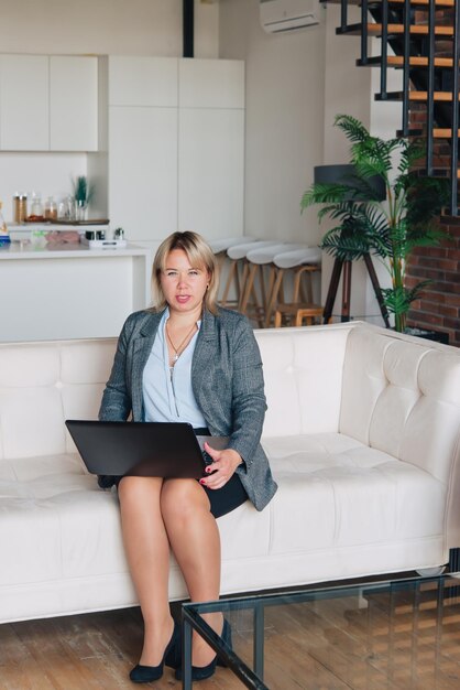 Teacher. Business woman at home working with laptop computer. Business woman portrait.