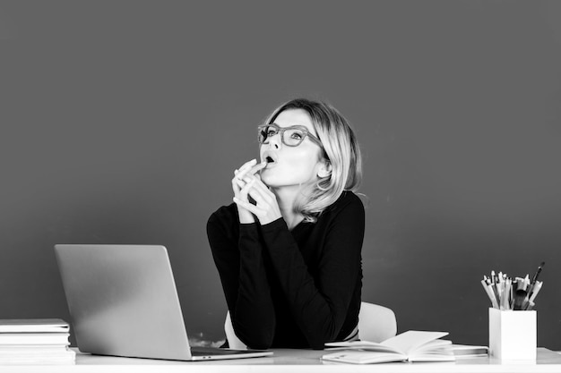 Teacher in classroom at university or college female student on\
board with computer laptop lesson se