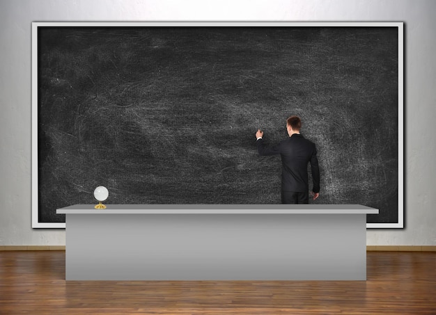 Teacher drawing on chalk board