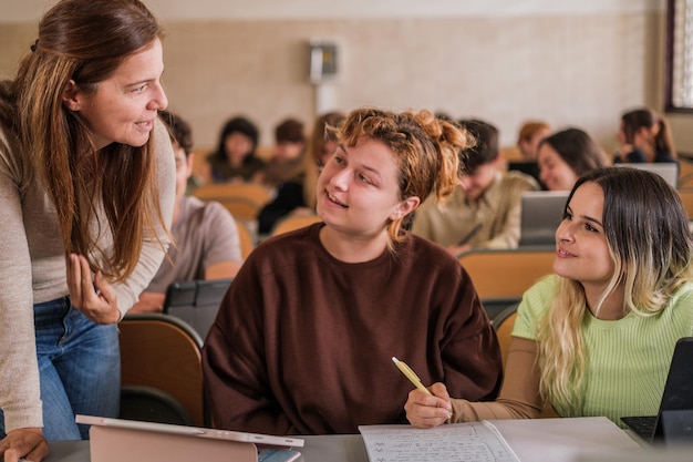 Teacher explaining individually to her students at the university