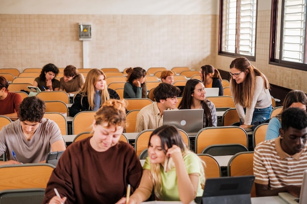 Teacher explaining to students individually while they do work focus on teacher