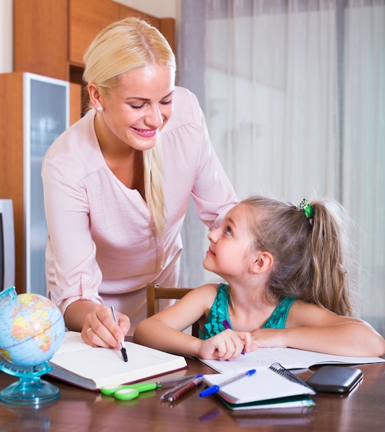 teacher and girl studying at home