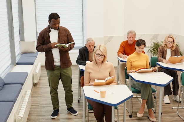 Teacher giving lecture for students at class