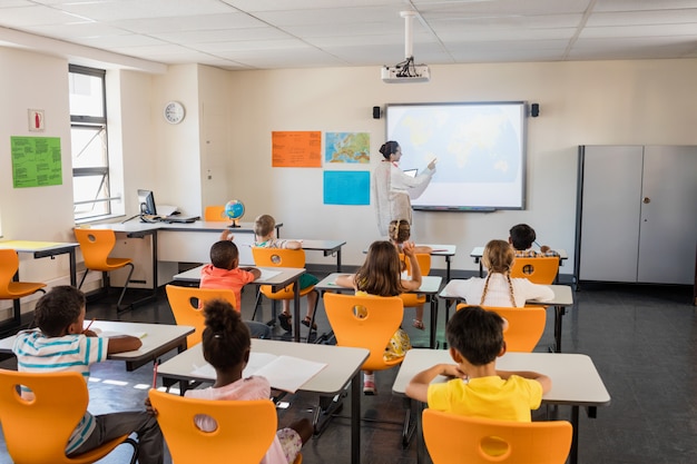 Teacher giving lesson to her students