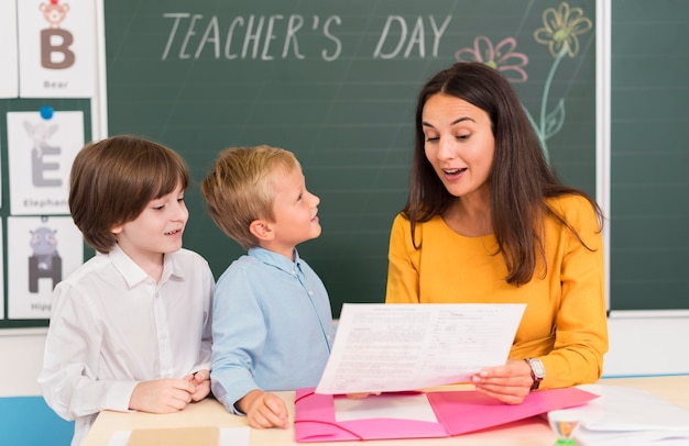 Teacher helping her students in class