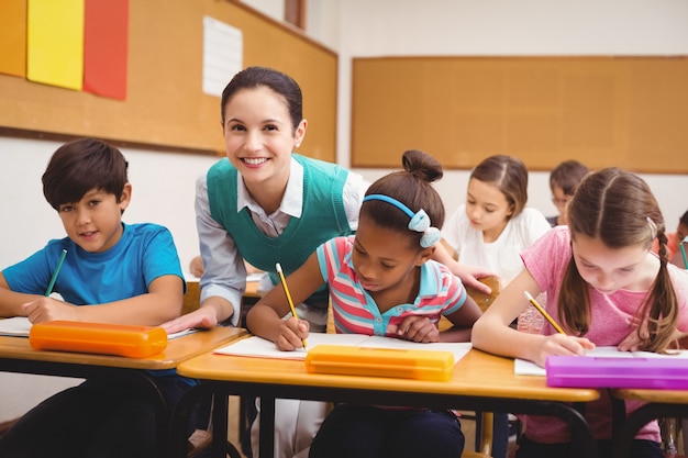 Teacher helping pupils during class