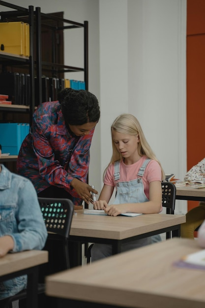 Photo teacher helping a student stock photo