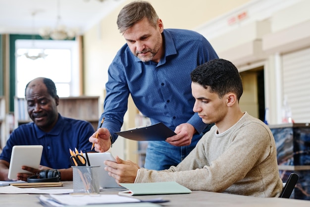 Teacher helping to do task