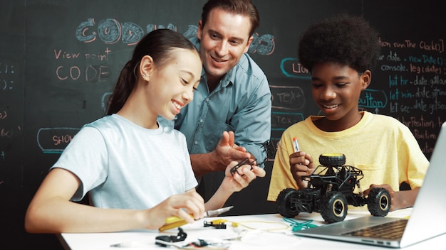 Teacher looking at laptop screen while explain car model system Edification