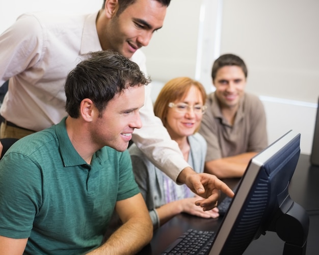 Teacher and mature student in computer room