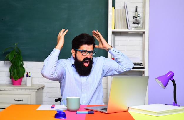 Teacher preparing for university exam exam in college school student bearded male student in glasses