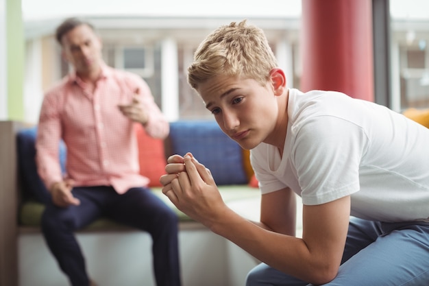 Teacher scolding student in library