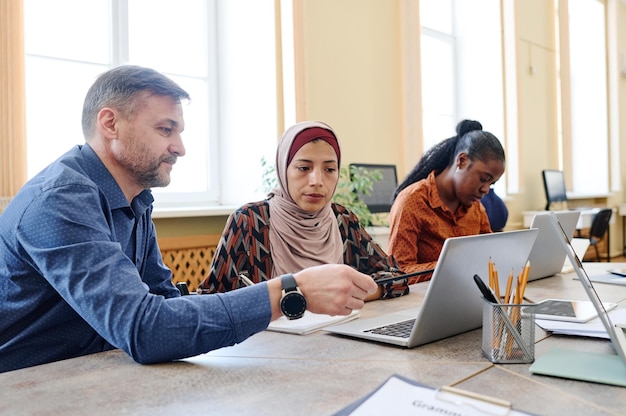 Teacher showing something to student