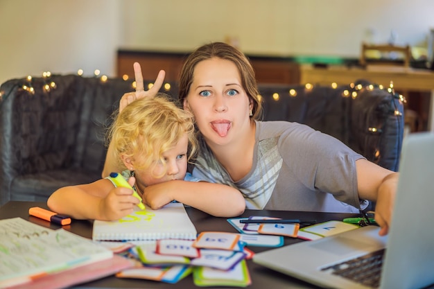 A teacher a tutor for home schooling and a teacher at the table Or mom and daughter Homeschooling