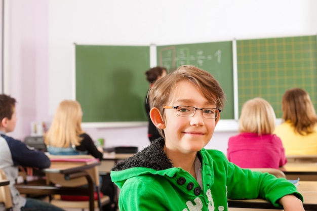 teacher with pupil in school teaching