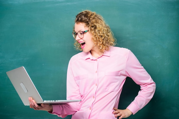 Teacher woman working on a laptop online education business school happy student in glasses with computer modern technology girl in modern school elearning concept Education via Internet