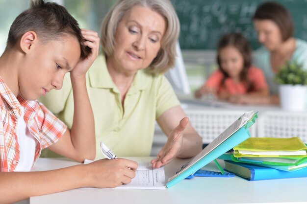 Teachers working with pupils in computer class