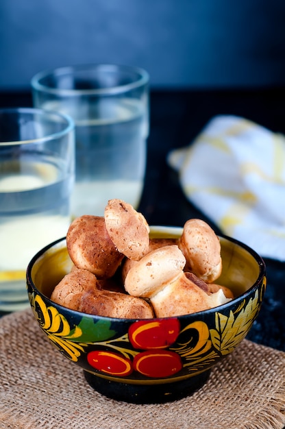 Tazza da tè con angelo tè e biscotti, tangerineon un tavolo nero