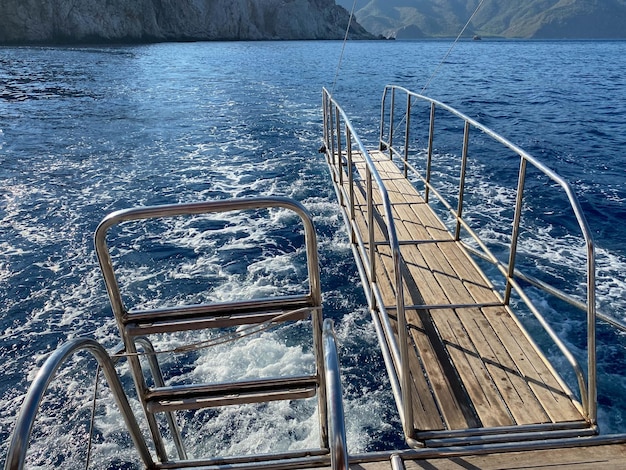 Teak and stainless steel gangway at the bow of a pleasure boat