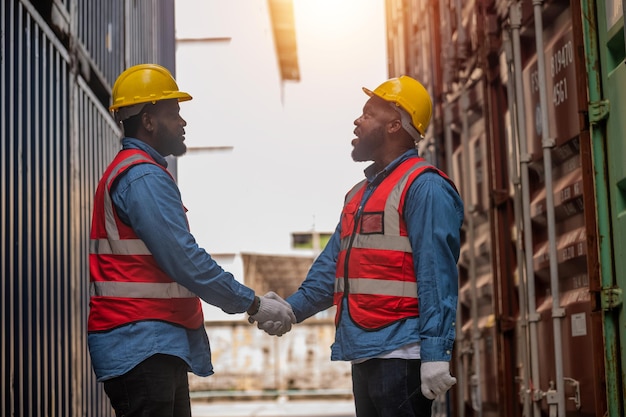 Team african american worker concept african american worker\
teamwork working in warehouse containers for logistic import export\
team black man worker shake hand