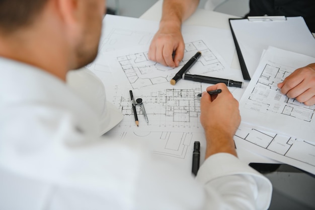 Team of architects people in group on construciton site check documents and business workflow