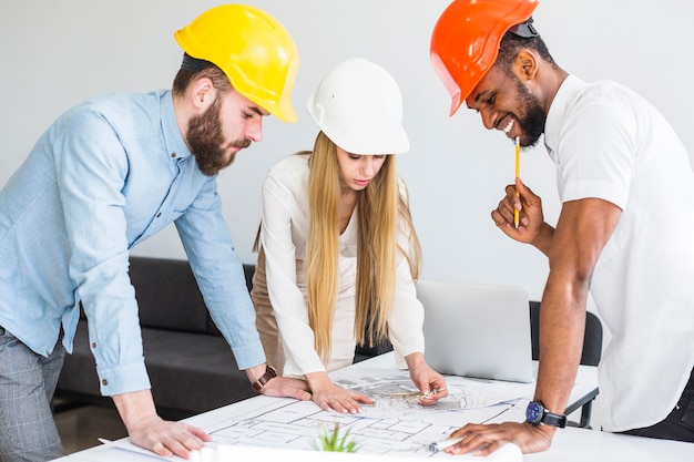 Photo team of architects working on construction plan